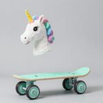 파스텔 민트색 미토 올뉴카 유아킥보드 실사용 사진, 넓은 광폭 LED 바퀴와 유니콘 헤드가 부착되어 있으며 아이가 안전하게 타고 있음